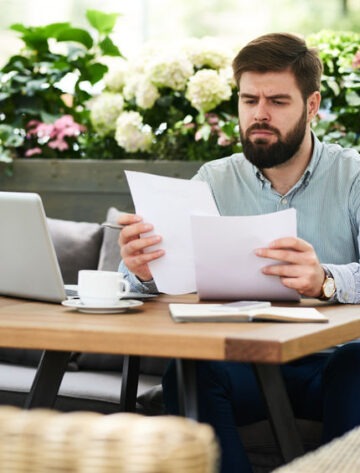 businessman comparing documents for certified translations